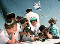 Young Israeli settlers play with army guns 14 Apri